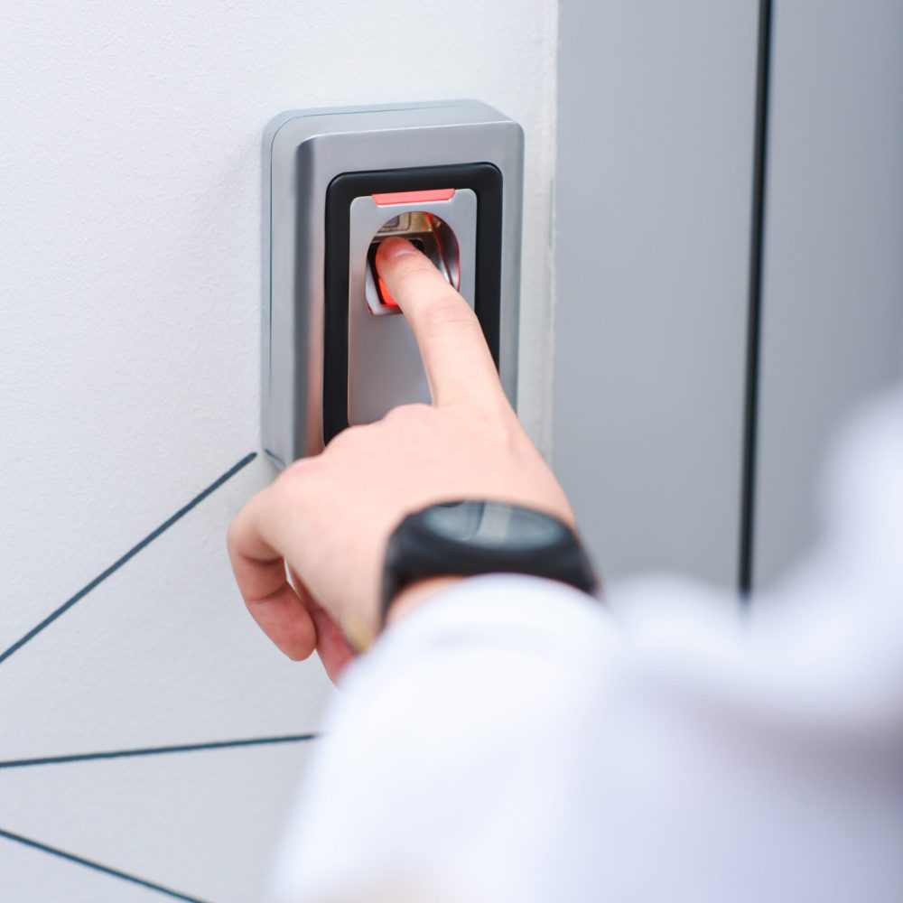 partial view of man with wristwatch pushing button of elevator